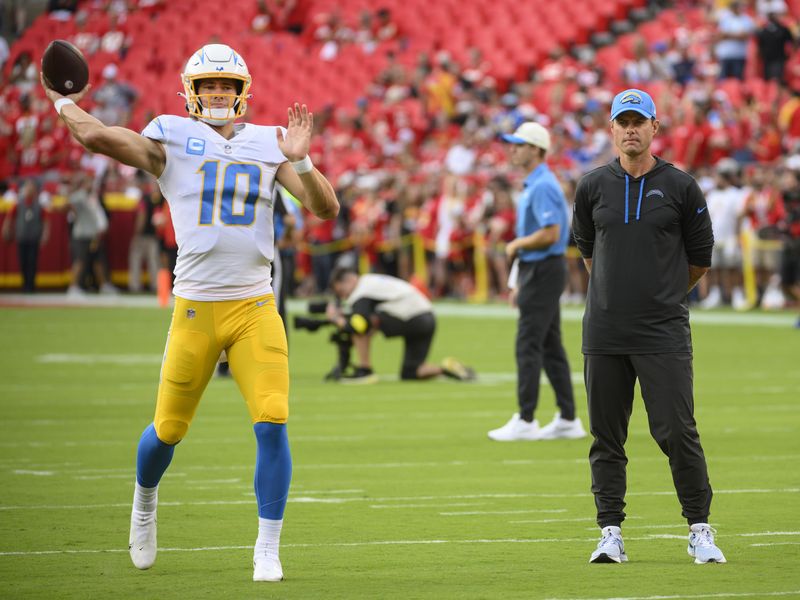 Los Angeles Chargers head coach Brandon Staley, right, watches Chargers quarterback Justin Herbert warm up