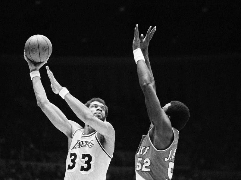 Los Angeles Lakers' Kareem Abdul-Jabbar hooks shot over Portland Trail Blazers' Jim Brewer