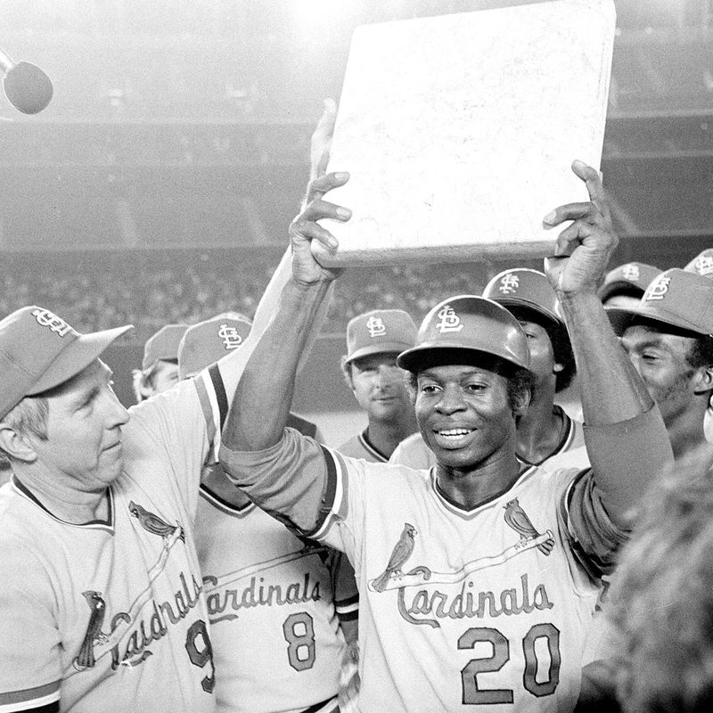 Lou Brock surrounded by teammates as he holds second base