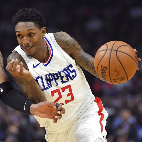 Los Angeles Clippers guard Lou Williams, right, drives by Atlanta Hawks guard Kent Bazemore during the second half of a basketball game, Monday, Jan. 8, 2018, in Los Angeles. The Clippers won 108-107. (AP Photo/Mark J. Terrill)