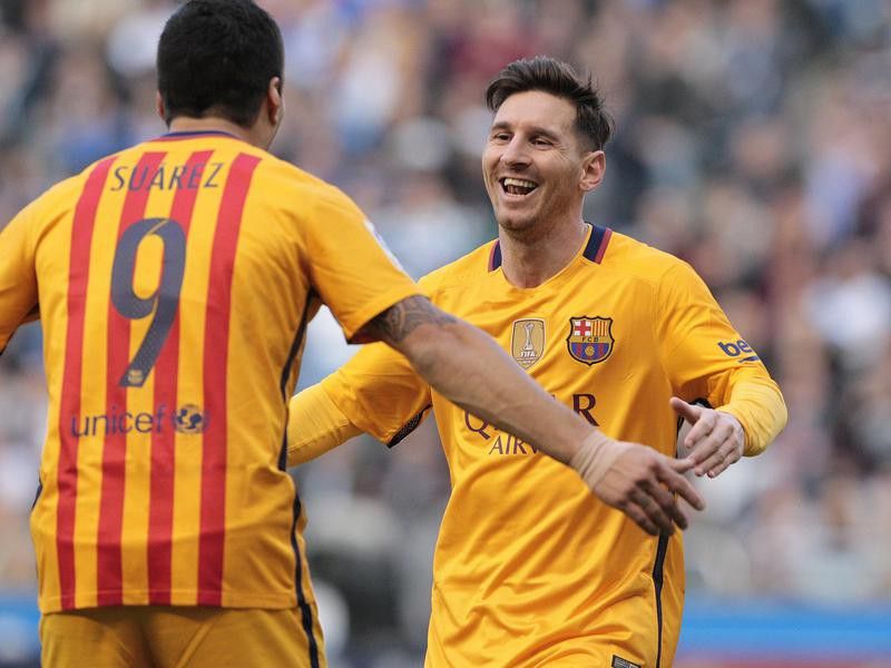 Luis Suarez congratulated by Barcelona's Lionel Messi