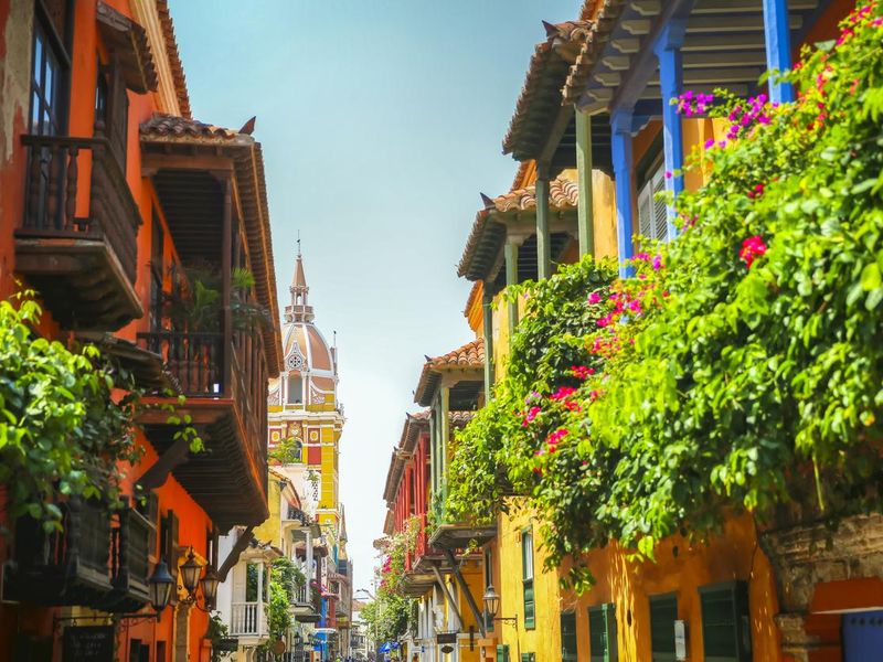 Lush balcony planters along the street looking towards town square in the old town of Cartagena Columbia
