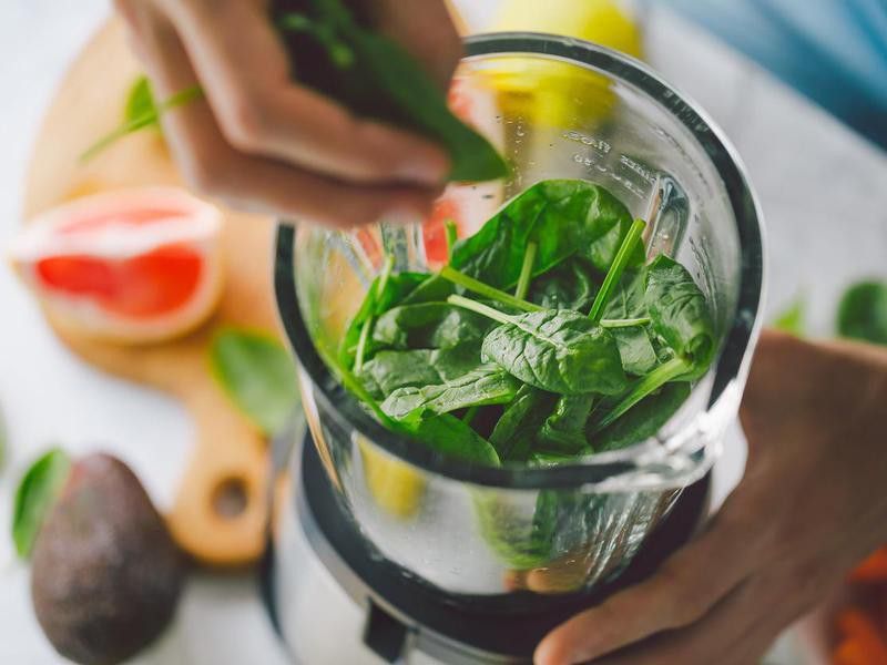 Making healthy smoothie with spinach