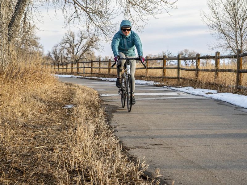 Male cyclist is biking on the Poudre River Corridor trail