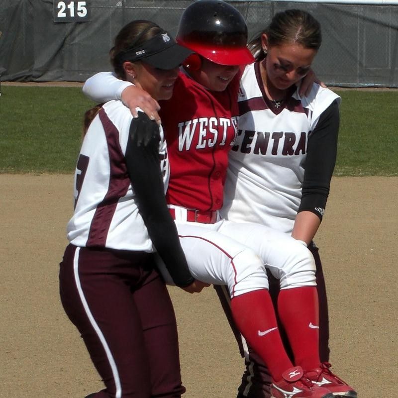 Mallory Holtman and Liz Wallace of Central Washington carry Sara Tucholsky of Western Oregon around the bases