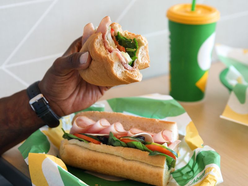 Man eating subway sandwich
