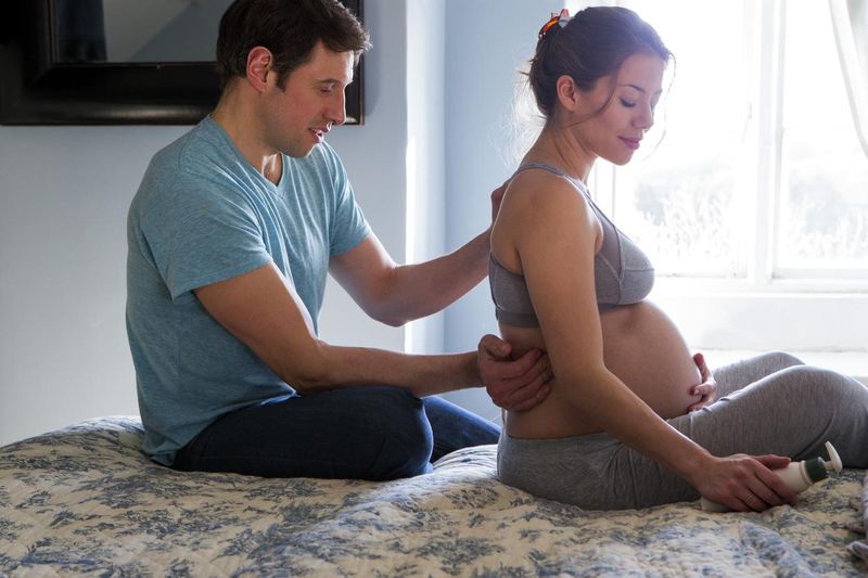 Man giving his pregnant wife a massage