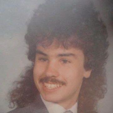 Man in a 1980s high school senior picture