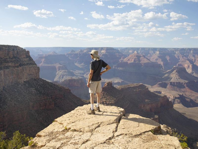 Man looking at view at Grand Canyon, South Rim. Arizona USA