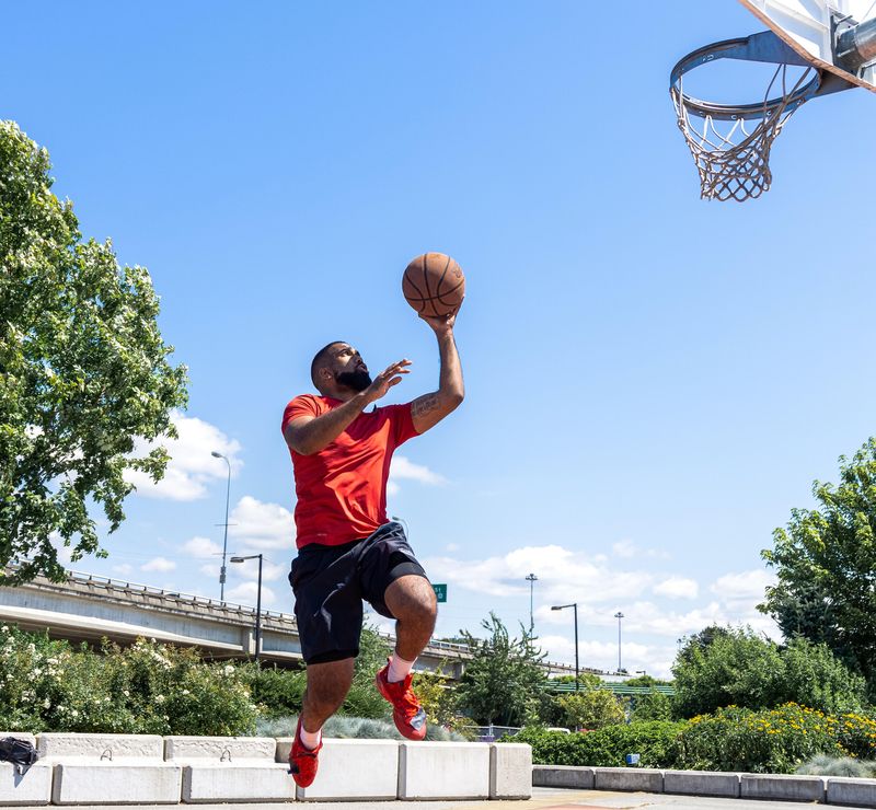Man playing basketball on an outdoor court