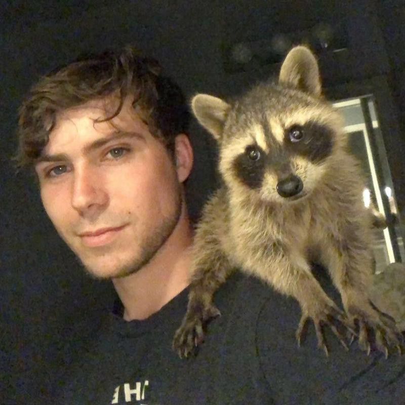 Man with pet racoon
