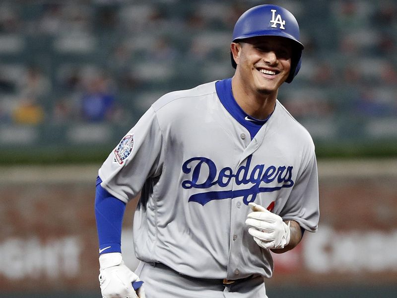 Manny Machado smiles while rounding bases