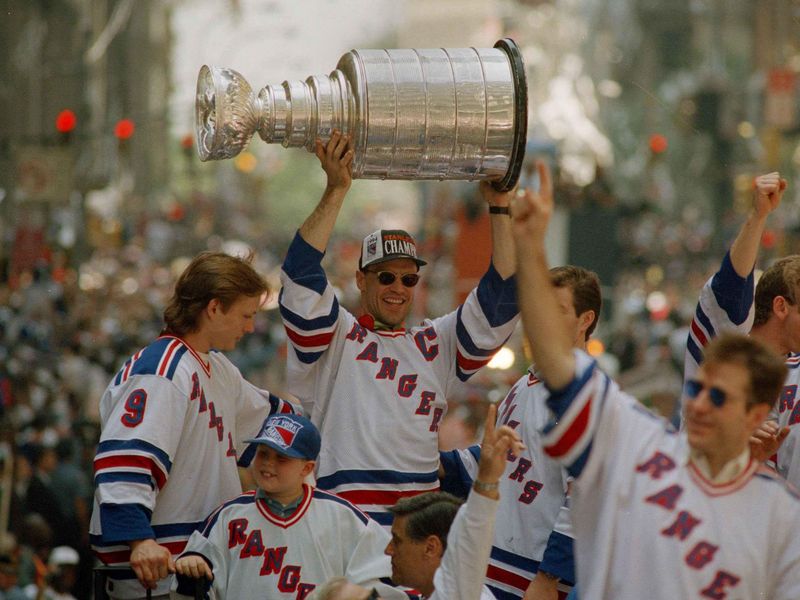 Mark Messier joined by other members of the team holds Stanley Cup during victory parade