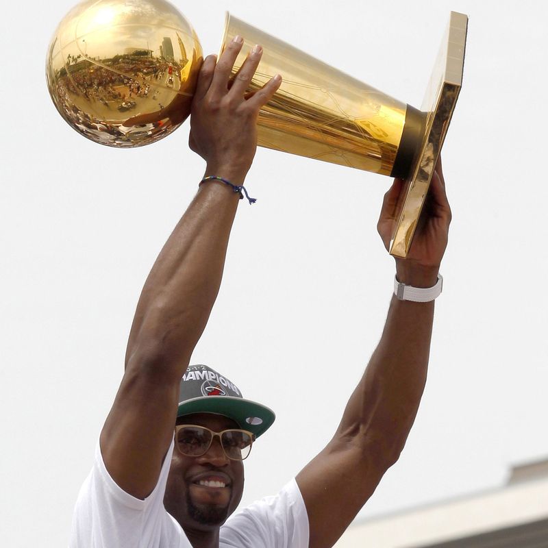 Miami Heat's Dwyane Wade holds up NBA Championship Trophy