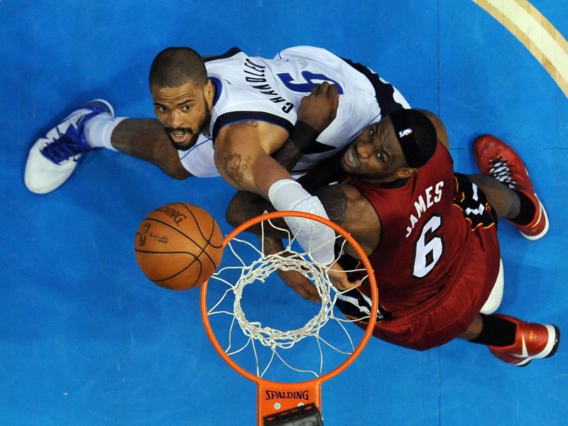 Miami Heat's LeBron James and Dallas Mavericks' Tyson Chandler go after rebound