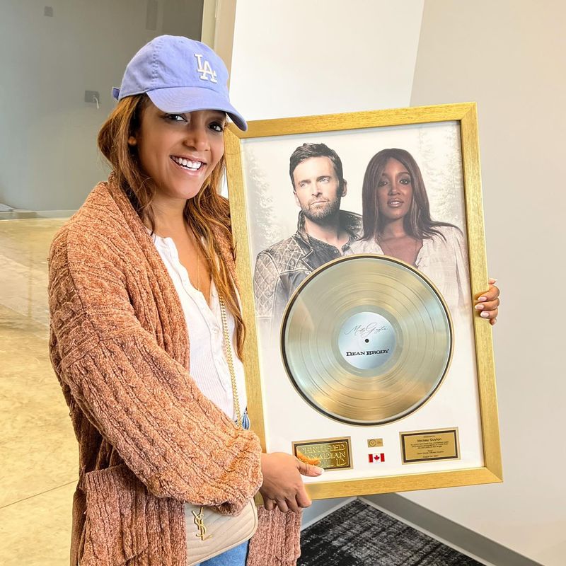 Mickey Guyton and gold record