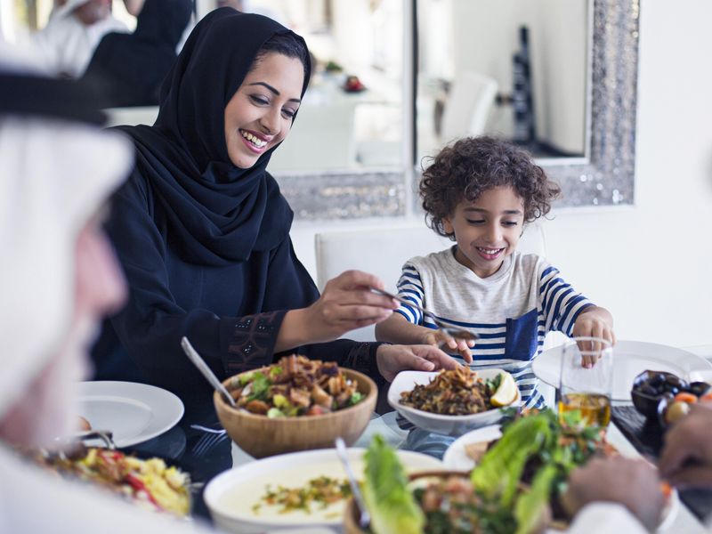 Middle Eastern family eating lunch at home in Dubai