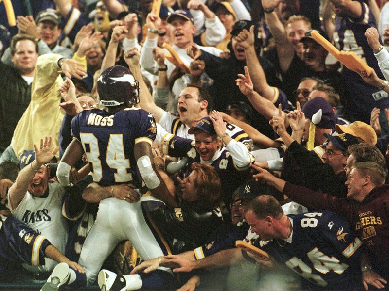 Minnesota Vikings wide receiver Randy Moss jumps into the crowd