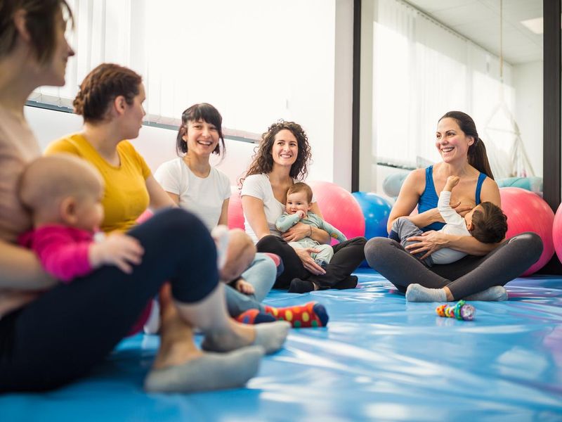 Mothers and babies on exercise class with a instructor