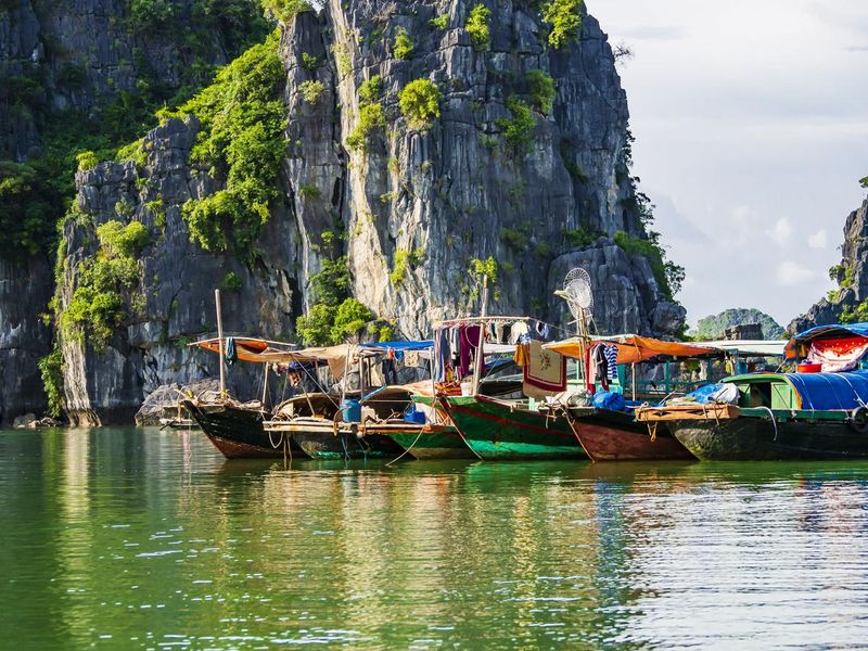 Multicolored fishing boats in Ha Long bay, Vietnam