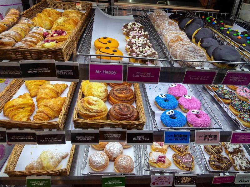 multicolored glazed doughnuts and other pastries at Dunkin donuts restaurant