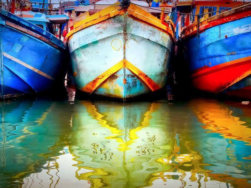 Multicolored old boat in a fishing port