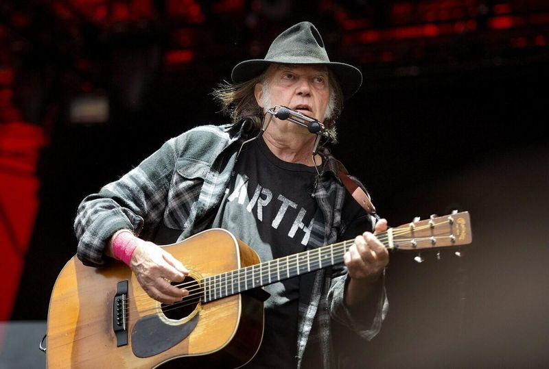 Neil Young playing guitar and singing
