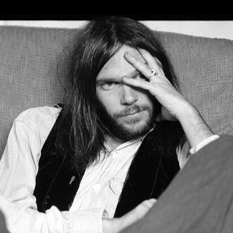 Neil Young sitting on a couch