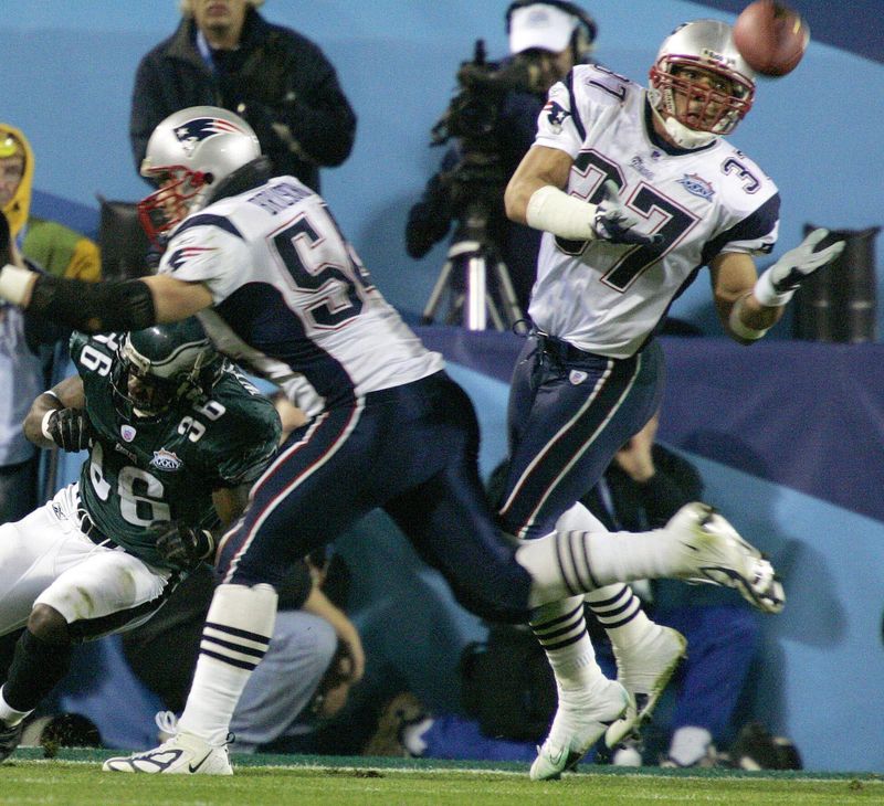 New England Patriots safety Rodney Harrison intercepts pass