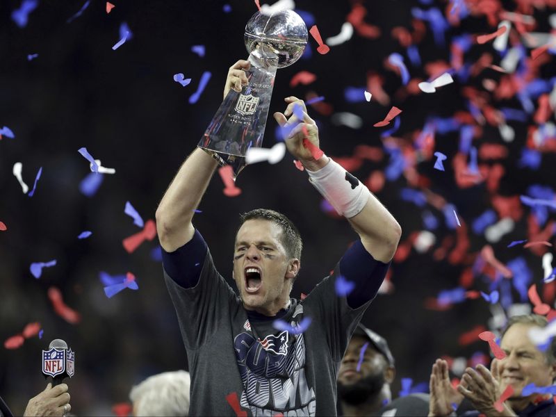 New England Patriots' Tom Brady raises the Vince Lombardi Trophy after defeating Atlanta Falcons