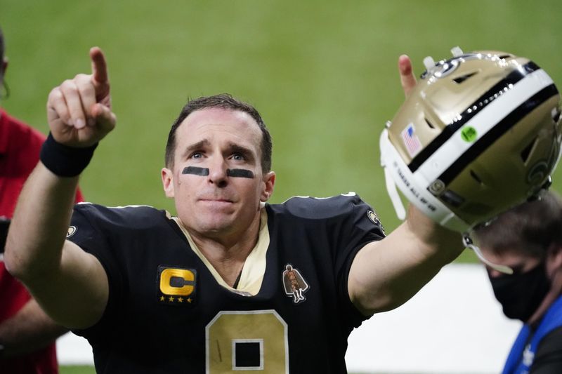 New Orleans Saints quarterback Drew Brees gestures to his family and fans