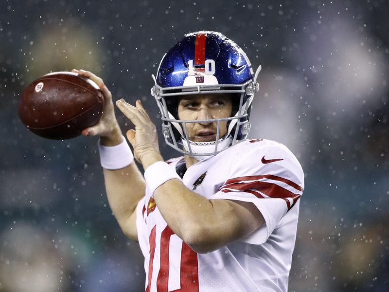New York Giants' Eli Manning warms up before NFL football game