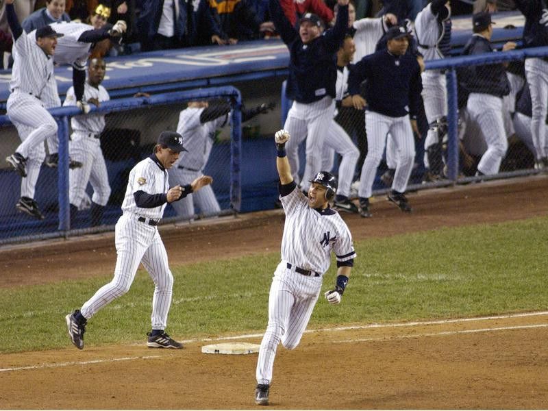 Florida Marlins catcher Ivan Pudge Rodriguez points to the sky, Yankees  Derek Jeter in foreground, after hitting a double against the New York  Yankees in game 4 of the 2003 MLB World