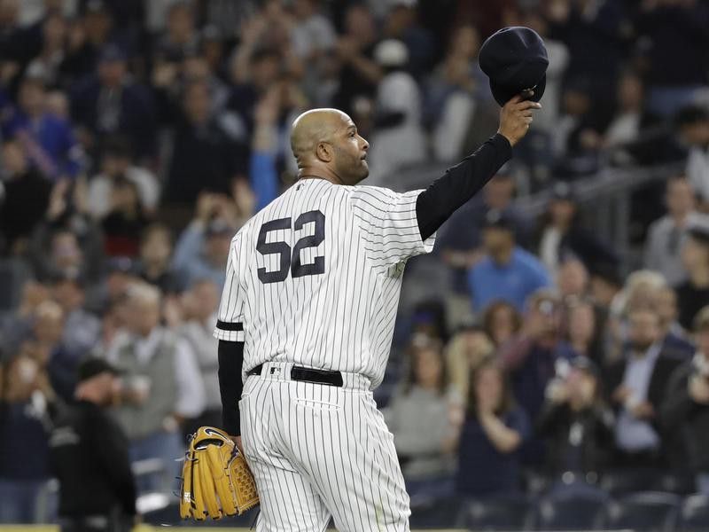 New York Yankees starting pitcher CC Sabathia gestures to fans