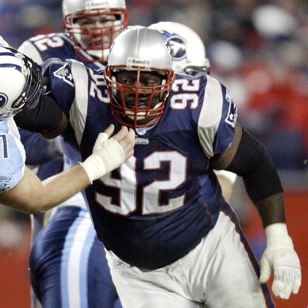 New England Patriots defensive end Ted Washington (92) works against the Tennessee Titans Justin Hartwig during the AFC divisional playoff game Saturday, Jan. 10, 2004, in Foxboro, Mass. The New England Patriots take on the Carolina Panthers in Super Bowl XXXVIII on Sunday, Feb. 1, 2004 in Houston. (AP Photo/Jim Rogash)