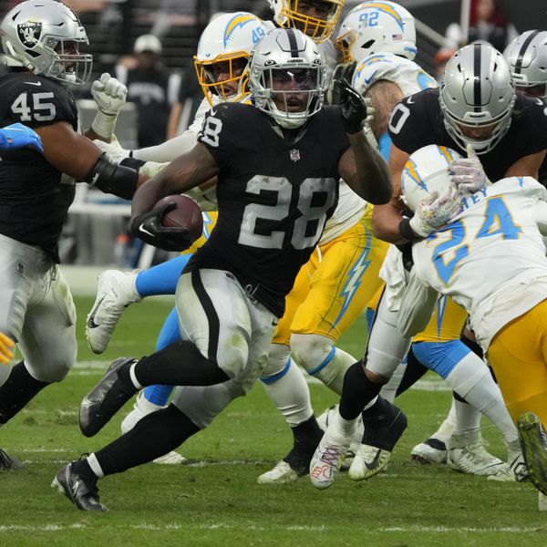 Las Vegas Raiders running back Josh Jacobs (28) runs the ball against the Los Angeles Chargers during the first half of an NFL football game, Sunday, Dec. 4, 2022, in Las Vegas. (AP Photo/Rick Scuteri)