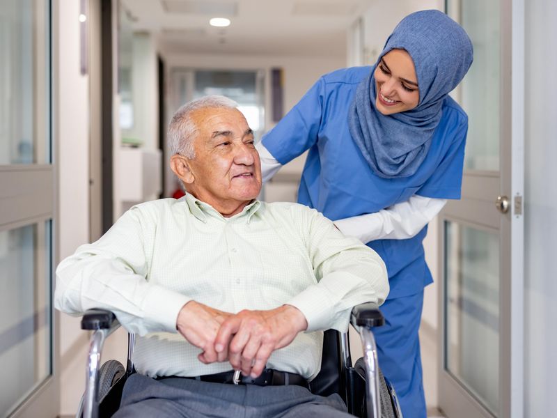 Nurse taking care of senior patient in wheelchair