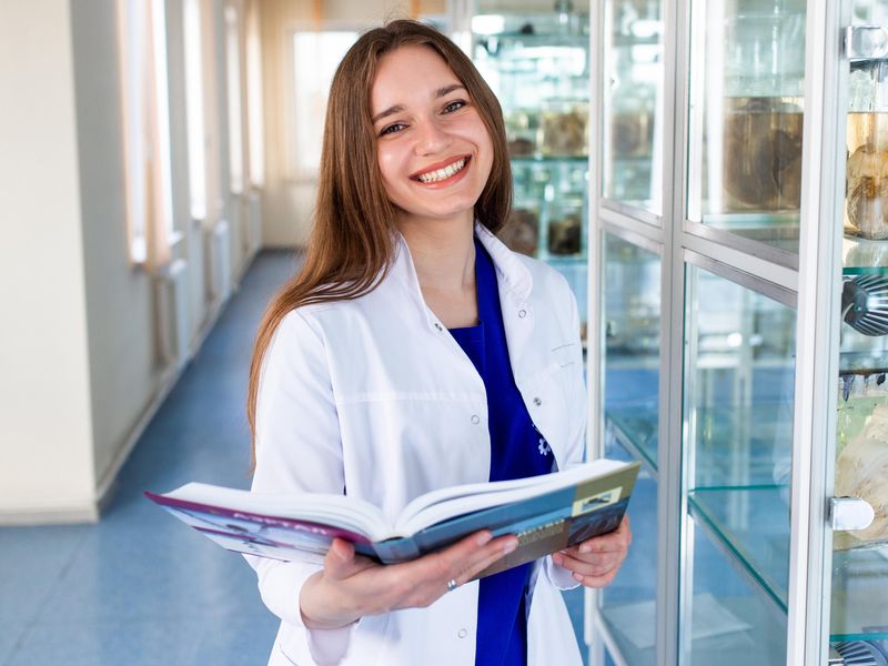 Nursing student holding a book at nursing school