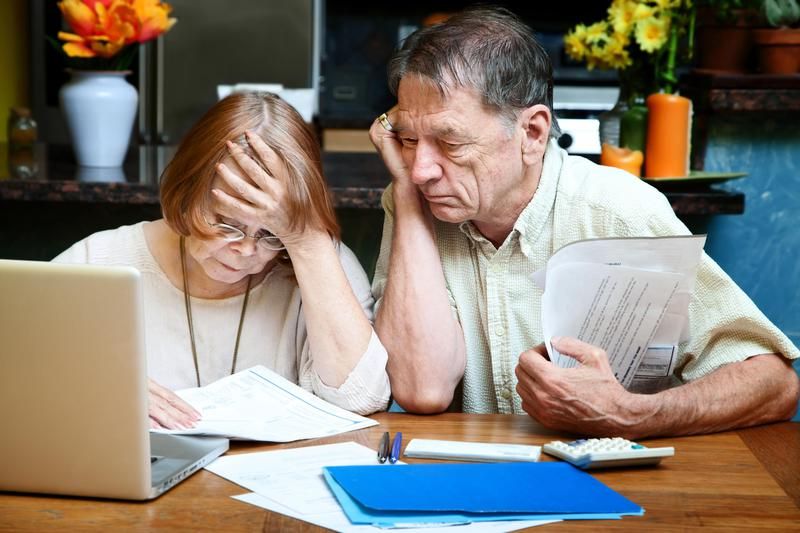 Old couple looking at retirement finances
