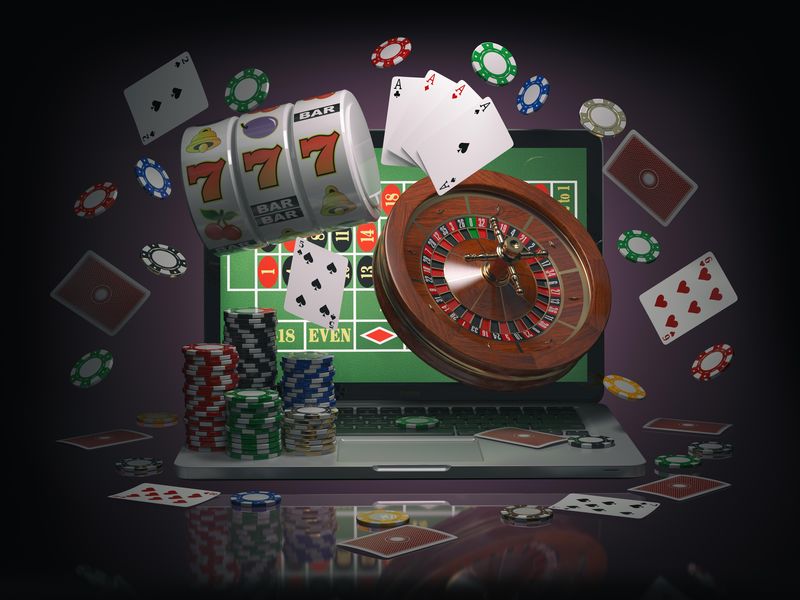 Online casino with laptop roulette, slot machine, chips and cards