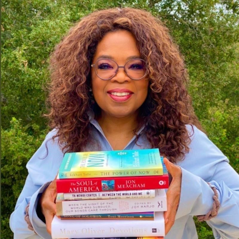 Oprah posing with books for her book club