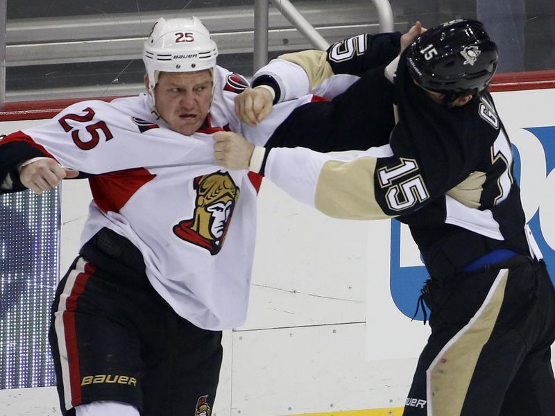 Ottawa Senators' Chris Neil lands a punch on the face of Pittsburgh Penguins' Tanner Glass