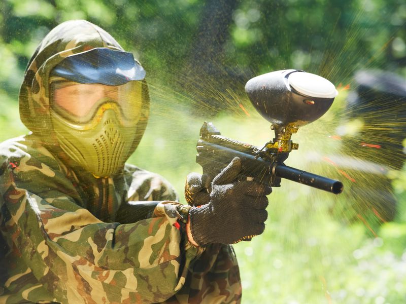 Paintball player being hit with paintball