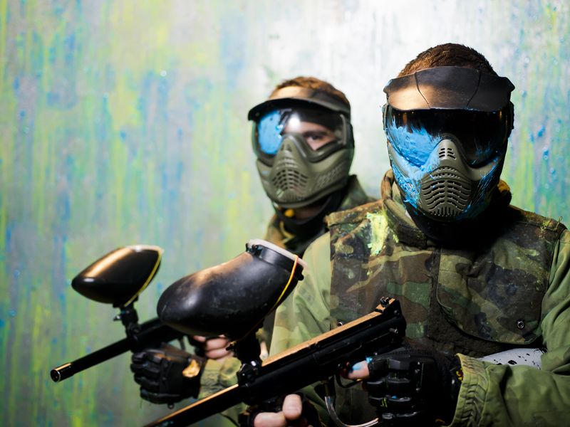 Paintball players with protective masks