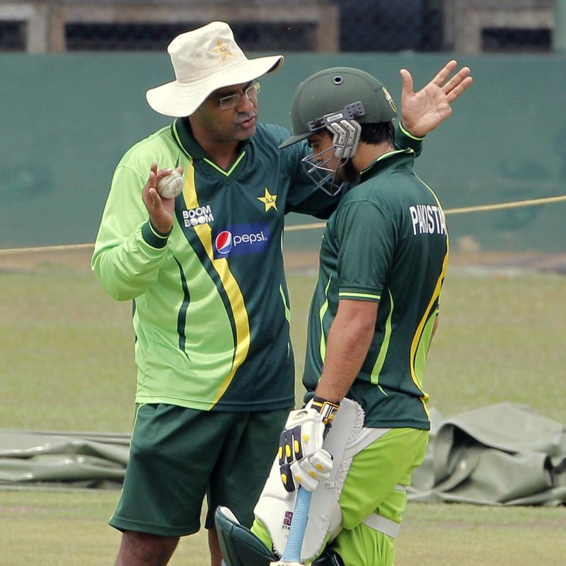 Pakistan's cricket coach Waqar Younis talks to batsman Ahmed Shehzad