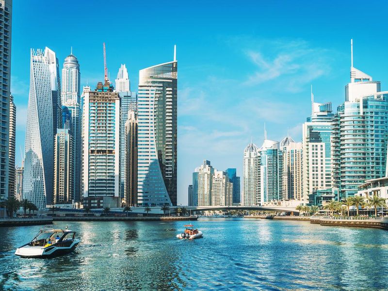 Panorama of Dubai Marina in UAE, modern skyscrapers and port with luxury yachts