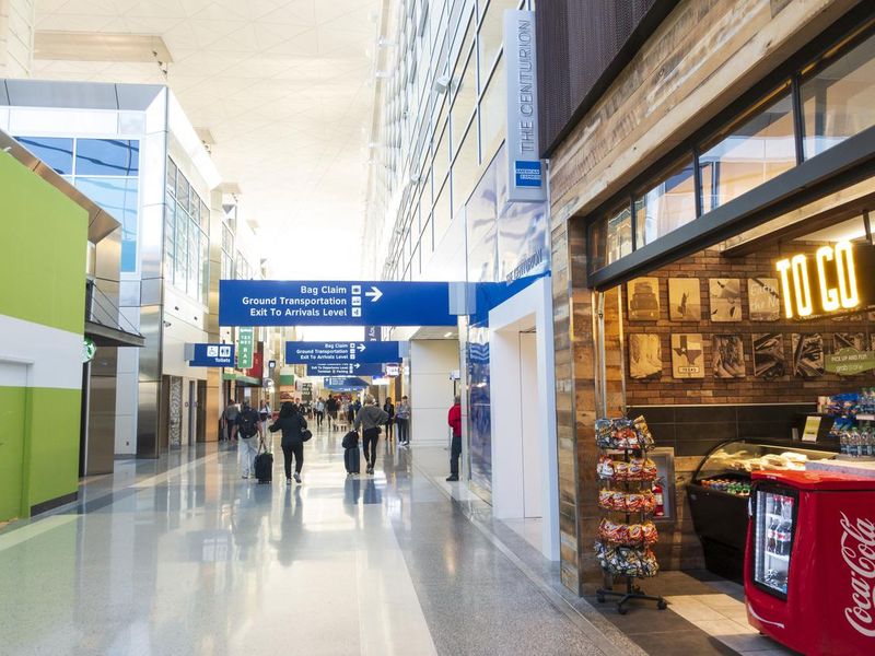 Passengers walking at terminal inside Dallas Fort Worth International Airport