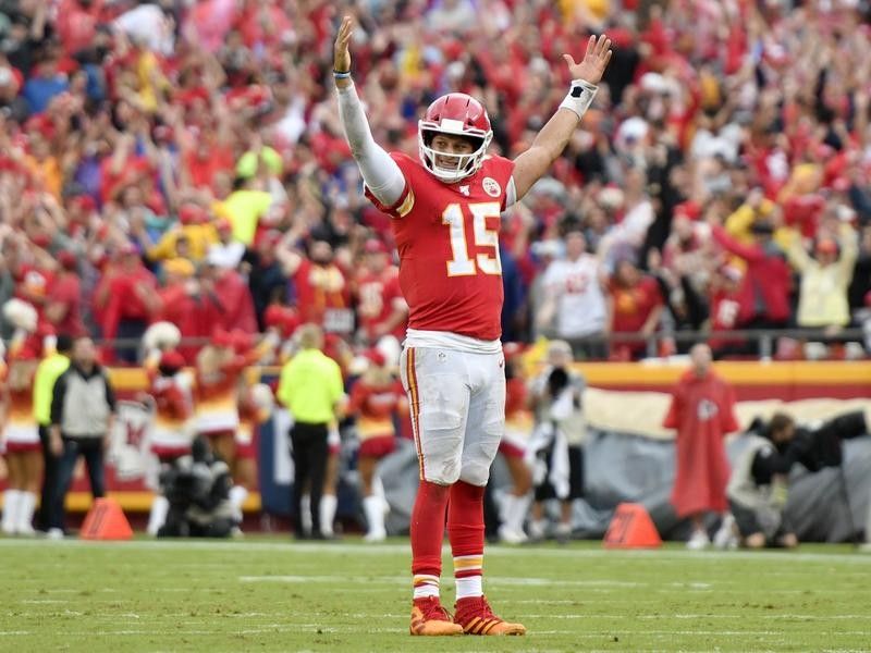 Patrick Mahomes raises his hands up after a touchdown