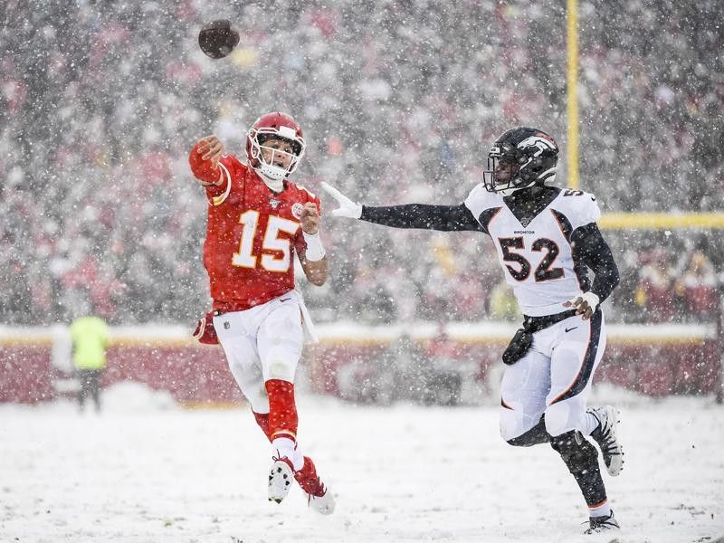 Patrick Mahomes throws in the snow against the Denver Broncos