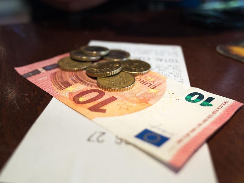 Paying Cafe Bill in Euros - Coins and Notes on Paper Bill